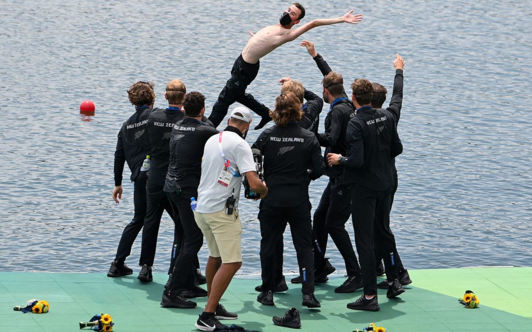 New Zealand men's eight throw Sam Bosworth (coxswain) into the water.