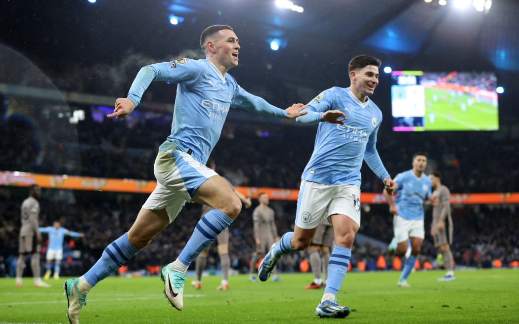 Phil Foden of Manchester City celebrates with team mate Julian Alvarez