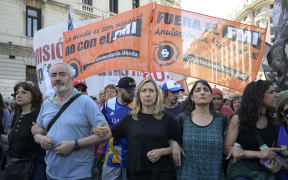 Argentina's former presidential candidate for the Frente de Izquierda y de los Trabajadores-Unidad party, Myriam Bregman (C), protests during the first demonstration against the new government of Javier Milei in Buenos Aires on December 20, 2023. Argentina is commemorating these days the 22nd anniversary of the protests of December 19 and 20 in 2001, the year of the worst economic, social and political crisis that the country has experienced in recent decades, which left 39 dead and ended with the resignation of President Fernando de la Rua. The protests called for today are the first faced by the new government of ultra-liberal Javier Milei. (Photo by JUAN MABROMATA / AFP)