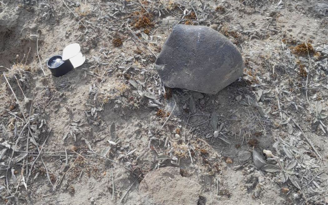 The rock, believed to be a meteorite, sitting on a glacial plain south of Lake Tekapo.