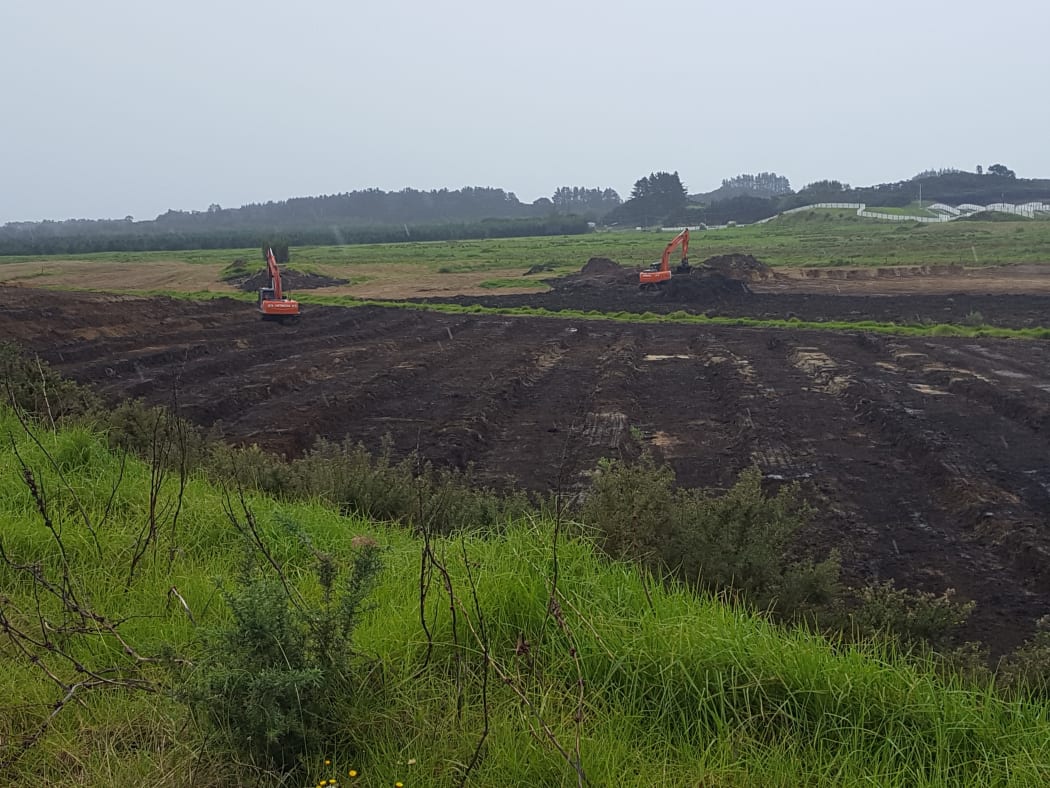 Diggers moving earth at Motutangi for new avocado orchards.