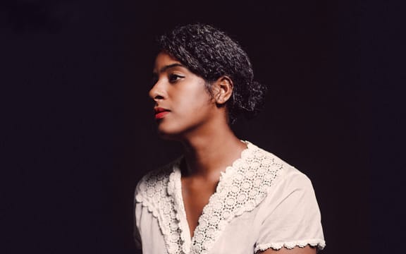 Album cover of Leyla McCalla's 'Breaking the Thermometer'. Leyla McCalla in profile.