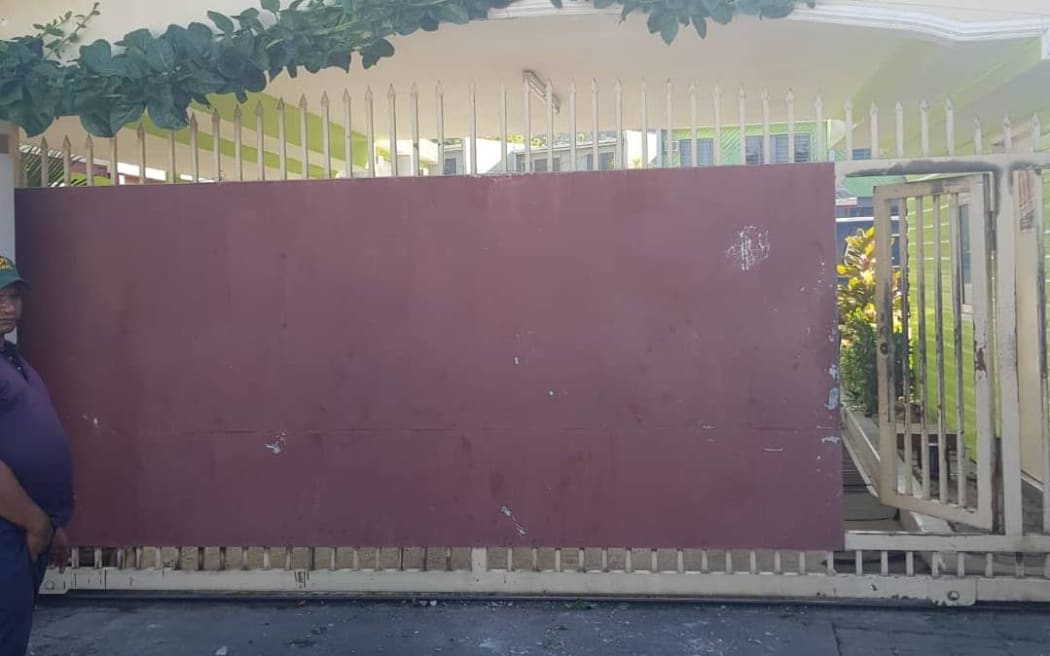 A guard outside the gate in Boroko.
