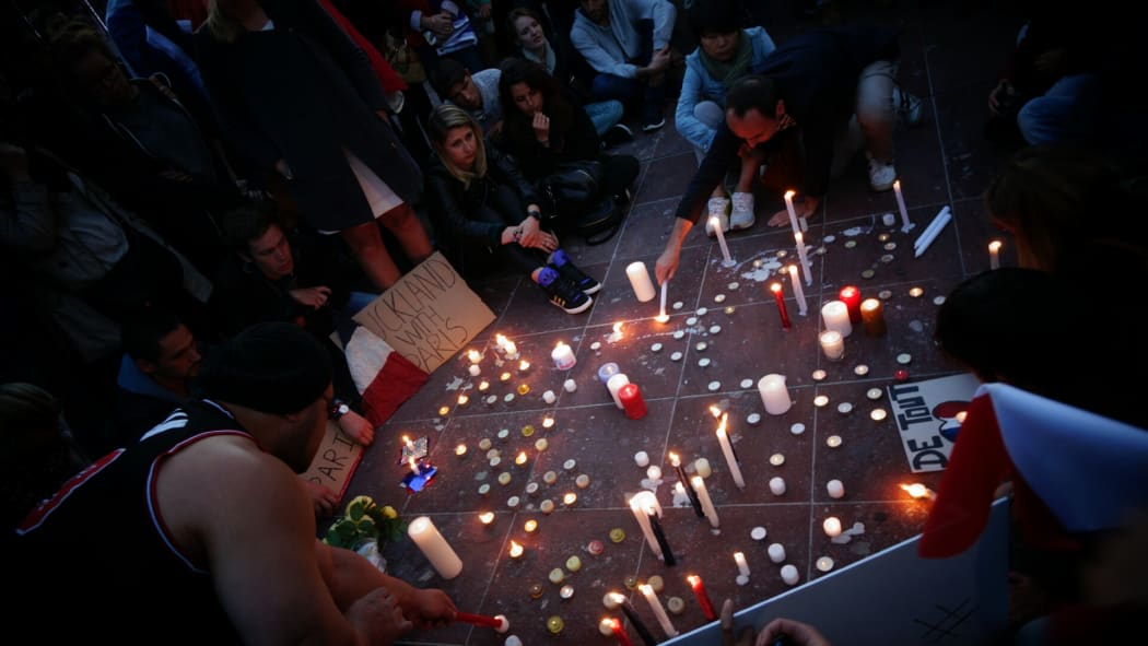 About 100 people gathered in Aotea Square, many of them French, following the deadly attacks.