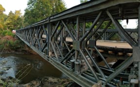 A bailey bridge has been installed between Mill Flat Road and Coatesville-Riverhead Highway in Auckland's Riverhead after severe flooding on 27 January washed away the existing bridge.