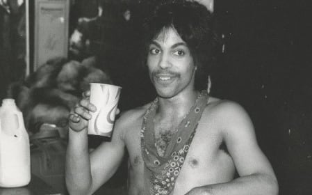 Prince sips some orange juice backstage during the Dirty Mind tour, 1981.
