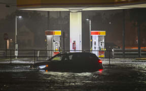 A vehicule is stranded on a water-flooded street after Hurricane Milton made landfall in Brandon, Florida on October 9, 2024. - Milton made landfall in Florida October 9, 2024 as an "extremely dangerous" Category 3 hurricane, packing life-threatening storm surge, extreme winds and flash flooding, the National Hurricane Center (NHC) said. "Data indicate the eye of Hurricane Milton has made landfall near Siesta Key in Sarasota County along the west coast of Florida," the NHC said in an 8:30 pm (0030 GMT Thursday) bulletin. (Photo by Miguel J. Rodriguez Carrillo / AFP)