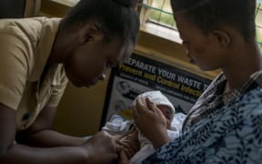 A baby receives vaccine at the maternity ward of the Ewin Polyclinic in Cape Coast, Ghana, in 2019. After Malawi, Ghana was the second country to launch the vaccine known by its lab initials as RTS,S but branded Mosquirix.
