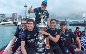 Team New Zealand's Dan Bernisconi, Peter Burling, Glen Ashby, Blair Tuke and Ray Davies with the Americas Cup After beating Luna Rossa.