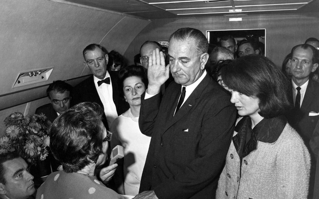 Photo dated November 22, 1963 courtesy the John F. Kennedy Presidential Library and Museum, Boston, shows Judge Sarah T. Hughes administering the Presidential Oath of Office to Lyndon Baines Johnson aboard Air Force One, at Love Field, Dallas Texas as Lady Bird Johnson (C-L), Jacqueline Kennedy (R), Jack Valenti, Cong. Albert Thomas, Cong. Jack Brooks, and Associate Press Secretary Malcolm Kilduff (holding microphone) witness the event. AFP HAND OUT   Cecil Stoughton-White House Photographs/John F. Kennedy Presidential Library and Museum-Hand Out
== RESTRICTED TO EDITORIAL USE / MANDATORY CREDIT: "AFP HAND OUT  Cecil Stoughton-WHITE HOUSE PHOTOGRAPHS/JOHN F. KENNEDY PRESIDENTIAL LIBRARY AND MUSEUM" / RESTRICTED TO SUBSCRIPTION USES / NO A LA CARTE SALES  / DISTRIBUTED AS A SERVICE TO CLIENTS== (Photo by JFK Presidential Library / AFP)