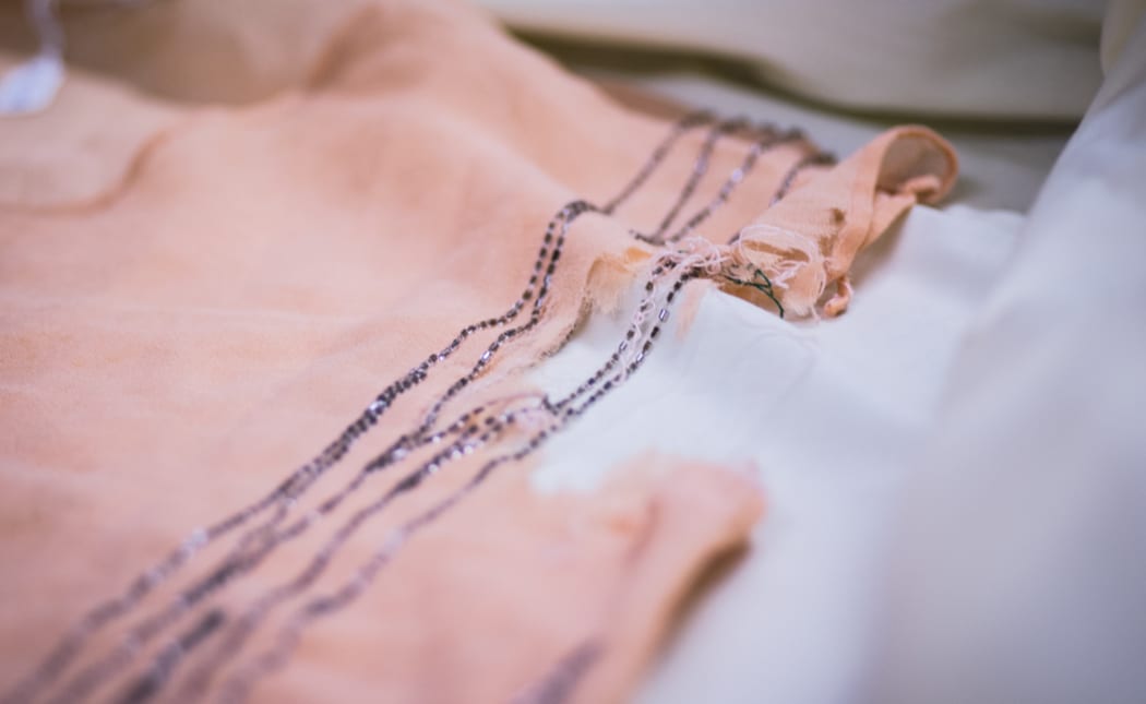 Detail of apricot crepe de chine glass beaded dress. 1920s. Gift of C A Trotter; Otago Museum Collection.