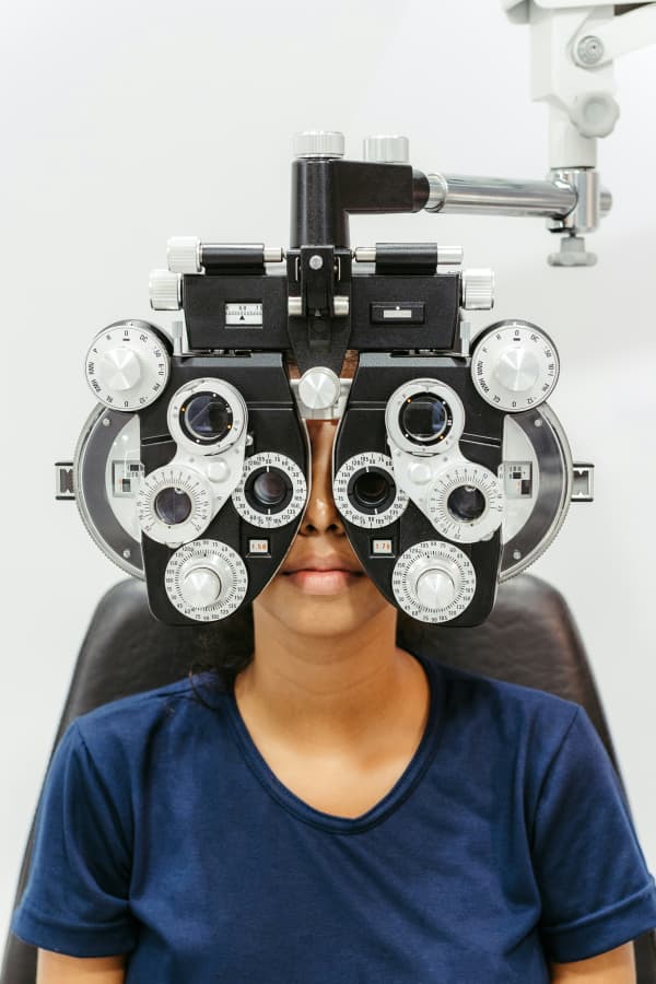 A woman with an optometry machine on her face.