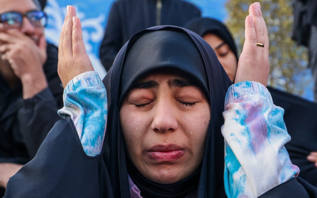 People mourn the death of Iran’s supreme leader Ayatollah Ali Khamenei, who was killed in joint US and Israeli strikes, at a square in Tehran on March 1, 2026. Ayatollah Ali Khamenei, Iran's supreme leader since 1989 and sworn enemy of the West, was killed in the opening salvo of a massive US and Israeli attack that extended into a second day on March 1, as the two powers seek to topple the Islamic republic. (Photo by ATTA KENARE / AFP)