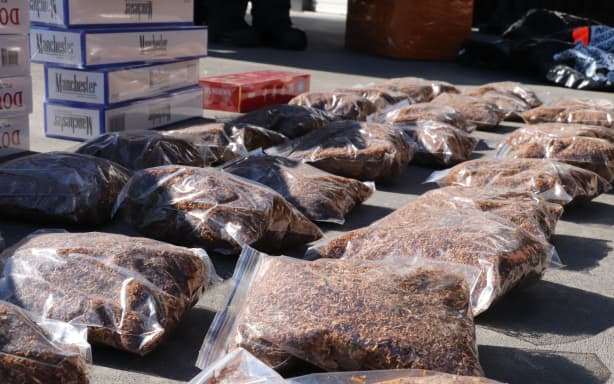 Five arrests and seizures of more than 1.3 million illegal cigarettes, along with approximately NZ$170,000 cash have been made in the first joint operation since the multi-agency Illicit Tobacco Action Group was established in May 2026. Operation Clarify, led by Customs and supported by Police and Health New Zealand, has been a six-month operation that culminated with 21 search warrants executed on eight retail outlets and six residential addresses in Rotorua, Waikato and Auckland believed to be linked to an illicit tobacco network.