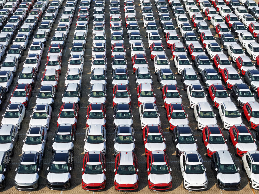 A large number of Chinese-made vehicles gather at Yantai Port waiting to be loaded for export in Yantai, China, on October 23, 2024. (Photo by Costfoto/NurPhoto) (Photo by CFOTO / NurPhoto / NurPhoto via AFP)