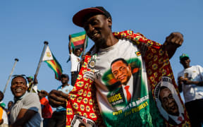 Supporters of Zimbabwe's ruling ZANU-PF party react after Zimbabwe's top court threw out an opposition bid to overturn presidential election results