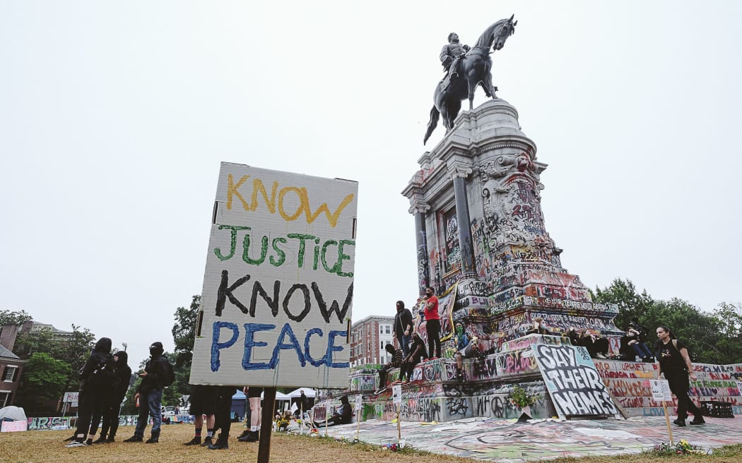 RICHMOND, VA - JUNE 20: A No justice no peace sign stands at the Robert E. Lee monument on June 20, 2020 in Richmond, Virginia.