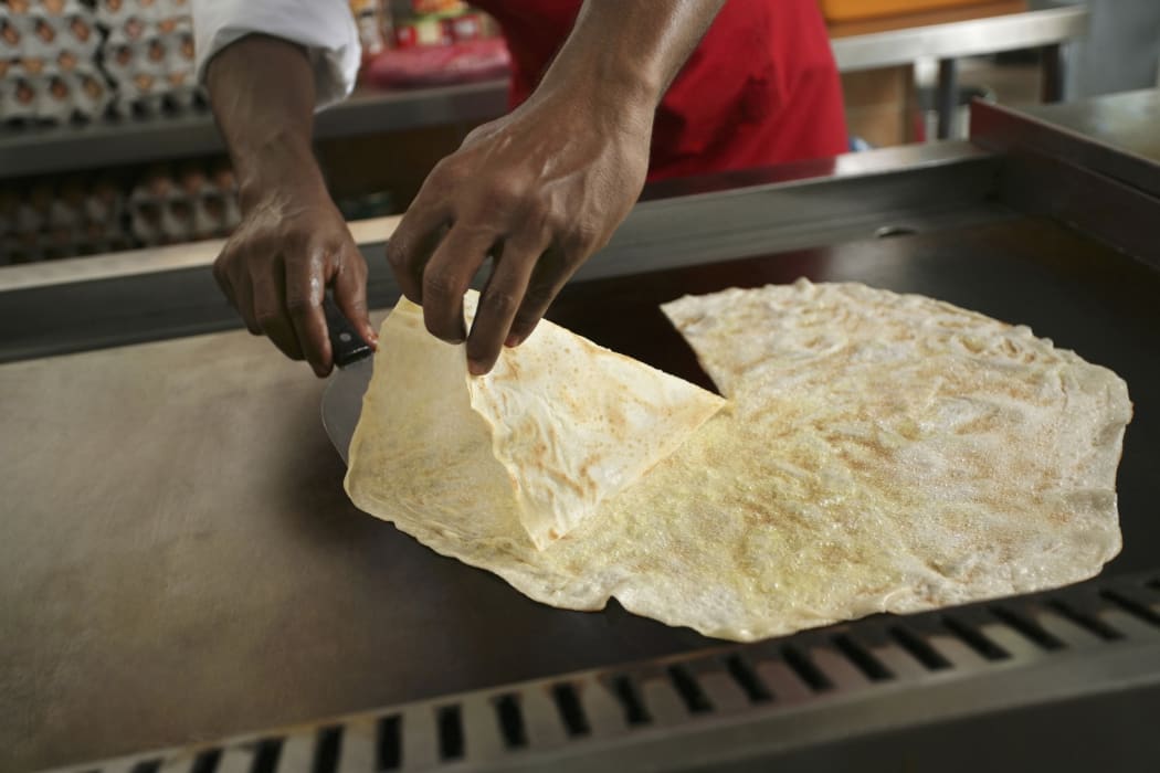 Man preparing roti tisu
