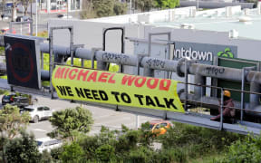 Two protesters atop a gantry on SH1 at Johnsonville