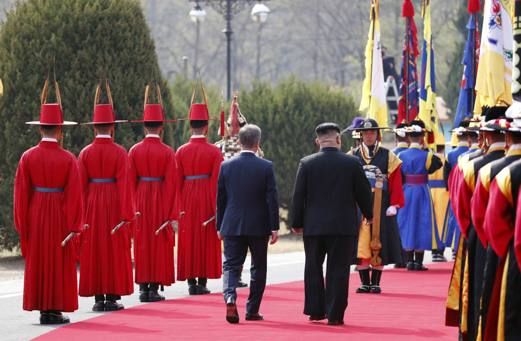 North Korea's leader Kim Jong Un and South Korea's President Moon Jae-in take part in a welcoming ceremony before walking to the official summit Peace House.