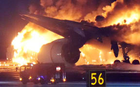 A Japan Airlines flight 156 catches fire on the C runway at Haneda Airport in Ota Ward, Tokyo on Jan.2nd, 2024, firefighting efforts are underway. The fire started on the aircraft just as it landed. Haneda Airport has blocked the runway. According to the airport authorities, the plane caught fire from the rear of the fuselage almost as soon as it landed and the plane collided with a Japanese Coast Guard (JCG) aircraft. All 379 passengers and crew members of the Japan Airlines airplane managed to escape from the fire after a collision with a JCG aircraft, whose five of the JCG plane crew had died. ( The Yomiuri Shimbun )
Kazuki Wakasugi / Yomiuri / The Yomiuri Shimbun via AFP