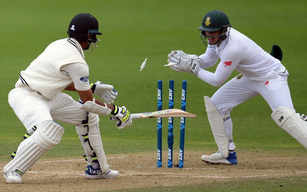 South African wicketkeeper Quinton De Kock stumps New Zealand's Jeet Raval.