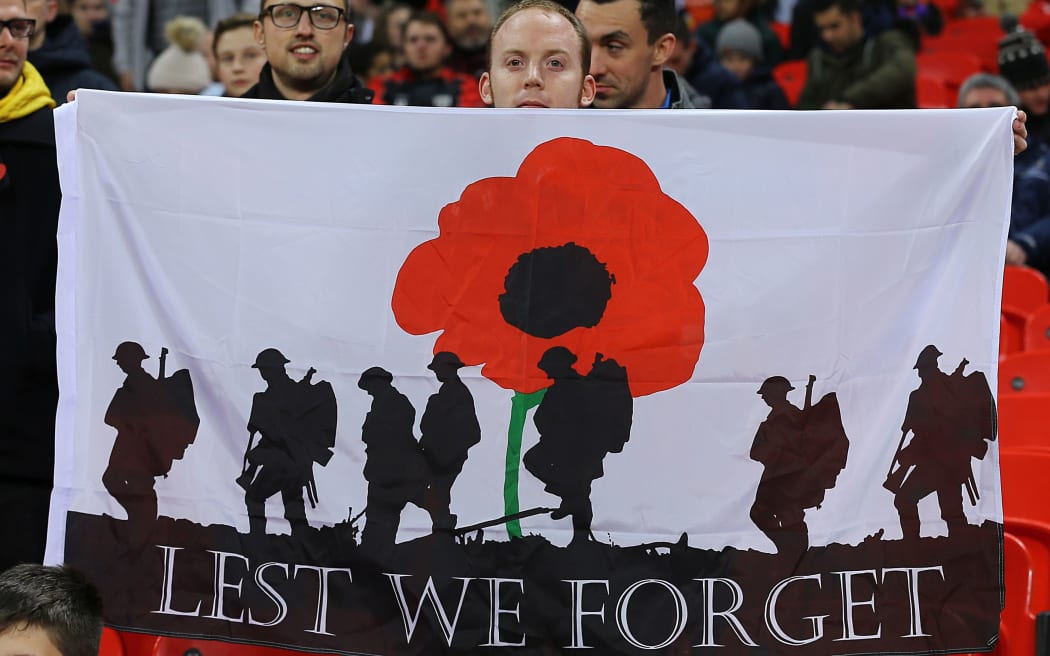 World Cup Qualifying Football. England versus Scotland. A fan Remembers with a poppy banner.