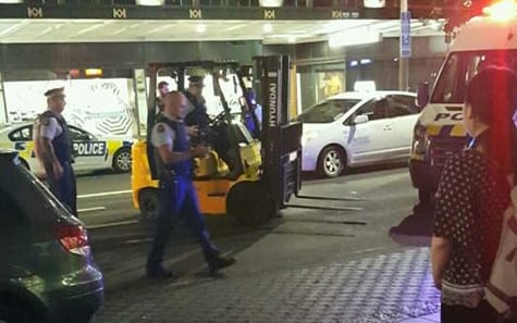 Police apprehend the forklift and its driver on Queen Street.