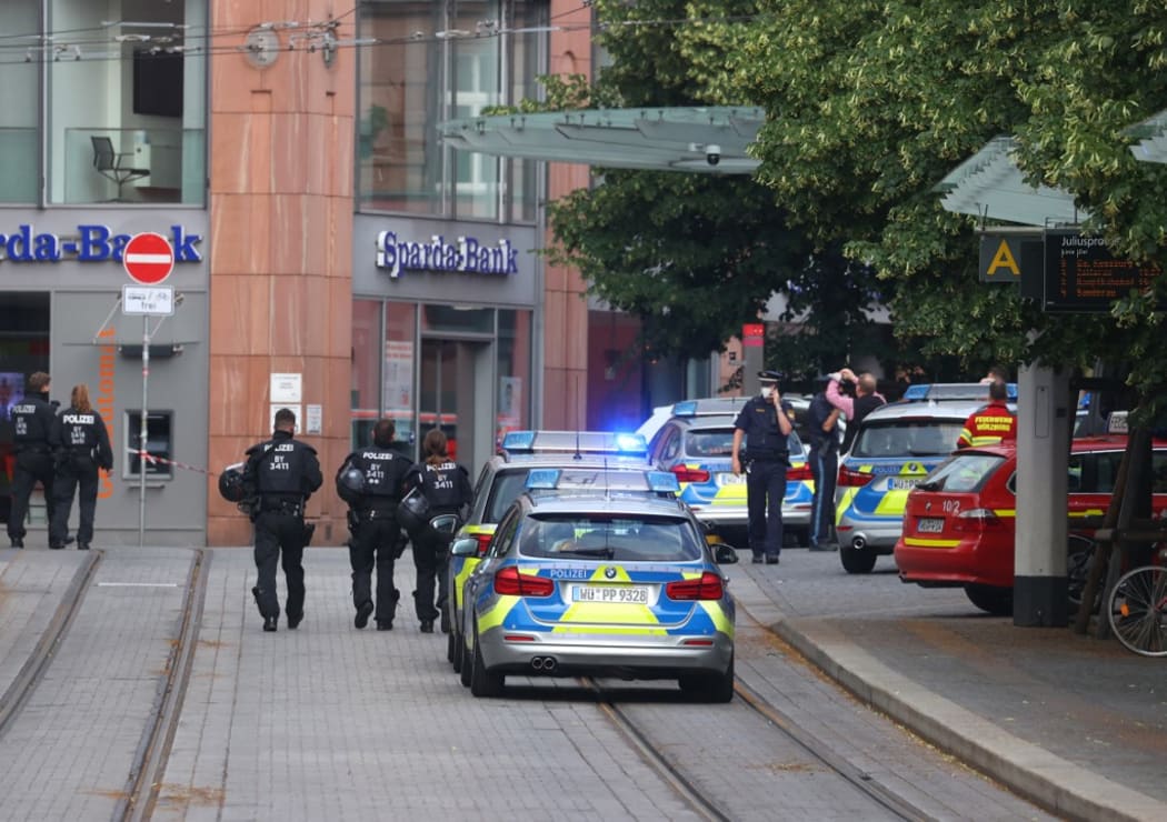 25 June 2021, Bavaria, Würzburg: Police officers run in the city center. Several people were killed in a knife attack in downtown Würzburg on Friday.