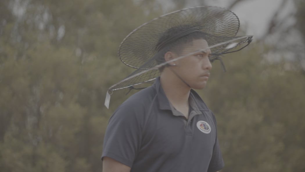 Piripi with his yabby net on his head