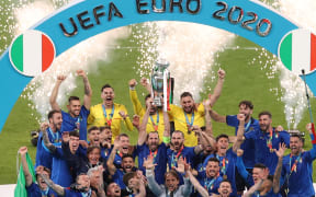 Italian team celebrates with the trophy after the Euro 2020 football final against England at Wembley, July 11, 2021.