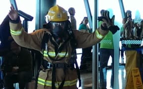 One of the firefighters crosses the finish line.