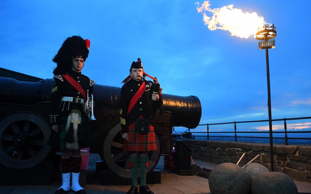 Army Cadet Sergeant Ciaran Cook (L) and Army Cadet Callum Lowther (R) attend a ceremony for the beacon lighting at Edinburgh Castle, in Edinburgh, on June 2, 2022, as part of Queen Elizabeth II's platinum jubilee celebrations. - More than 2,800 beacons are lit at Buckingham Palace and across the UK, including atop the four highest peaks, as well as on the Channel Islands, the Isle of Man, and British Overseas Territories. Flaming tributes will be seen in 54 Commonwealth capitals across five continents, from Tonga and Samoa in the South Pacific to Belize in the Caribbean.