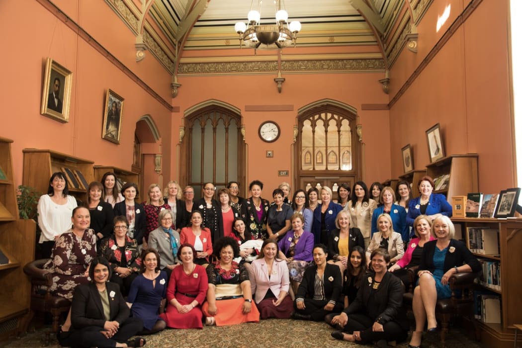 Women MPs recreate a photo of all male MPs taken in 1905 in the Reading Room of the Parliamentary Library.
