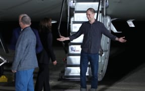 Freed prisoner Evan Gershkovich is greeted by U.S. Vice President Kamala Harris as he walks off a plane after arriving back in the United States on August 1, 2024 at Joint Base Andrews, Maryland.