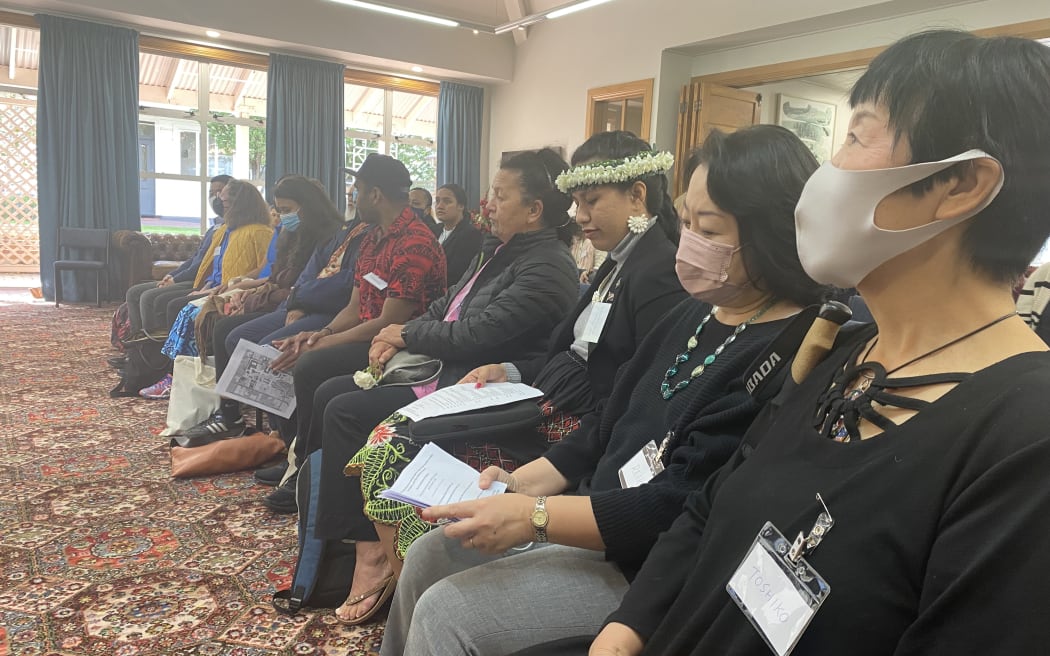 Toshiko Tanaka and Reiko Tashiro wearing mask, sitting at event. Toshiko Tanaka was exposed to the atomic bomb while on her way to school, 2.3 km from the hypocentre.