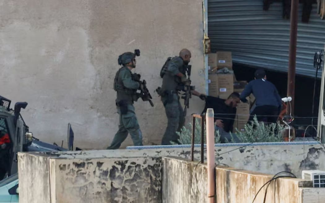Israeli soldiers were detaining two Palestinians during an operation in Jenin.