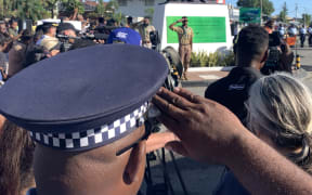 A Solomon Islands police officer salutes the Coastwatchers Monument at Point Cruz in Honiara during the 80th anniversary of the WWII Battle of Guadalcanal.