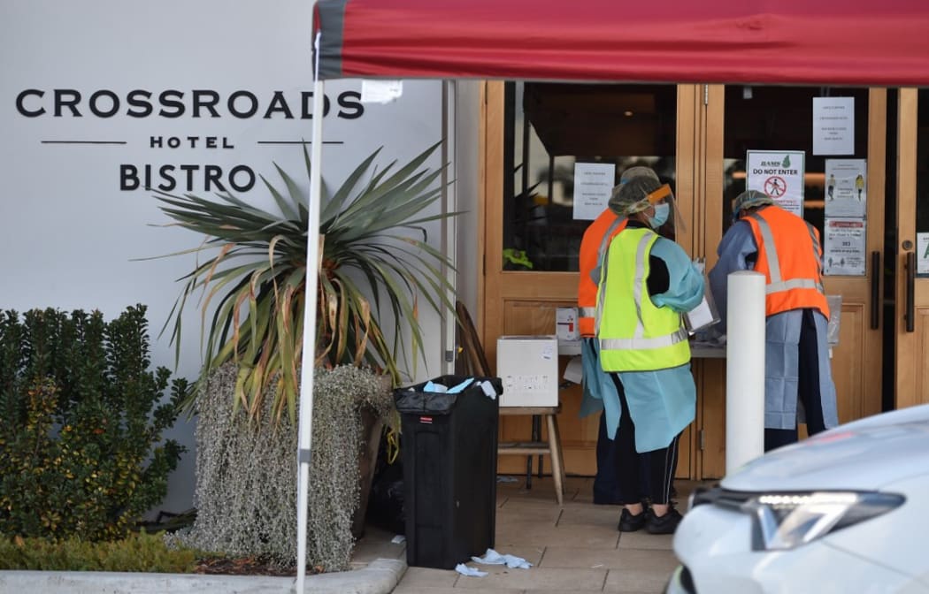 Medical workers are seen at a COVID-19 coronavirus testing station at the Crossroads Hotel, a popular drinking spot where at least 21 infections had been linked to a cluster there.