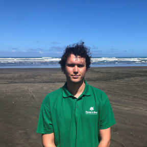 Carl Morgan wearing green shirt on Muriwai Beach