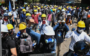 Protesters wearing protective gear take part in a demonstration against the military coup in Yangon over the weekend.