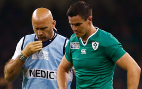 Johnny Sexton leaves the field injured in Ireland's RWC match against France.