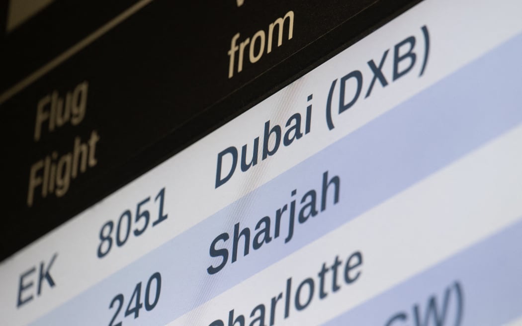 03 March 2026, Bavaria, Munich: "Dubai" is written on an advertisement at Munich Airport. A special Emirates airline flight with German vacationers is expected there on Tuesday. The plane had taken off from Dubai. According to a spokesperson for the travel group Tui, around 200 of the passengers are guests of the company. Photo: Armin Weigel/dpa (Photo by ARMIN WEIGEL / dpa Picture-Alliance via AFP)