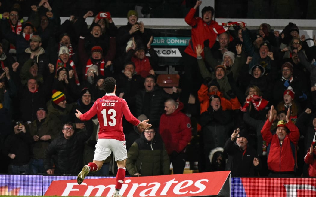 Liberato Cacace celebrates after scoring the opening goal for Wrexham in their third round FA Cup match against Nottingham Forest at Wrexham, January 9, 2026. (Photo by Oli SCARFF / AFP)