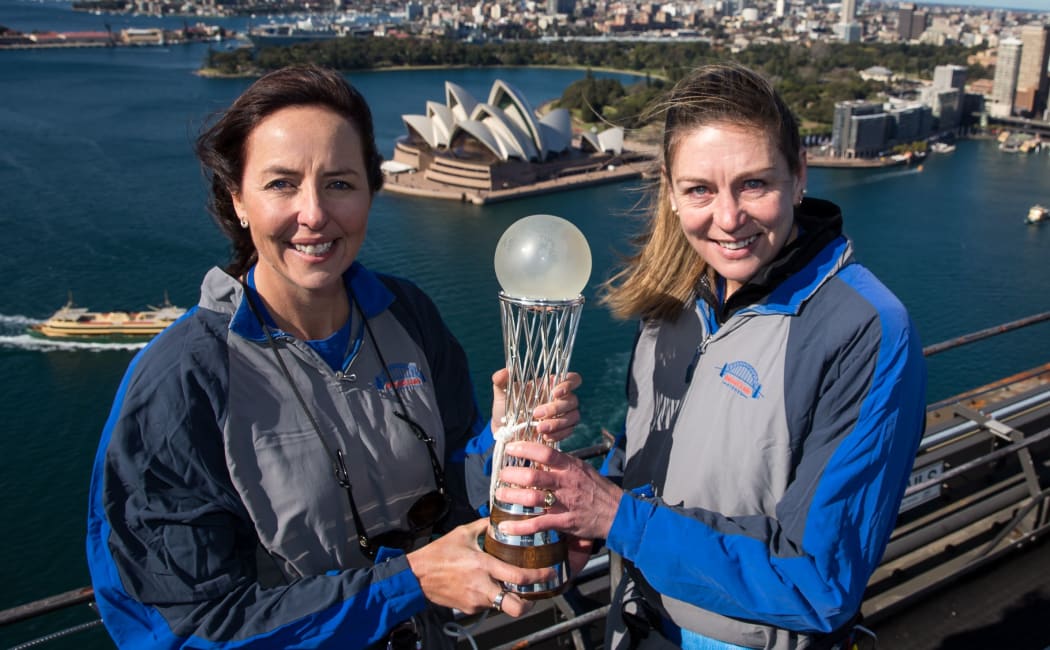 Netball greats Liz Ellis (left) and Irene van Dyk hold the World Cup aloft on the Sydney Harbour bridge.