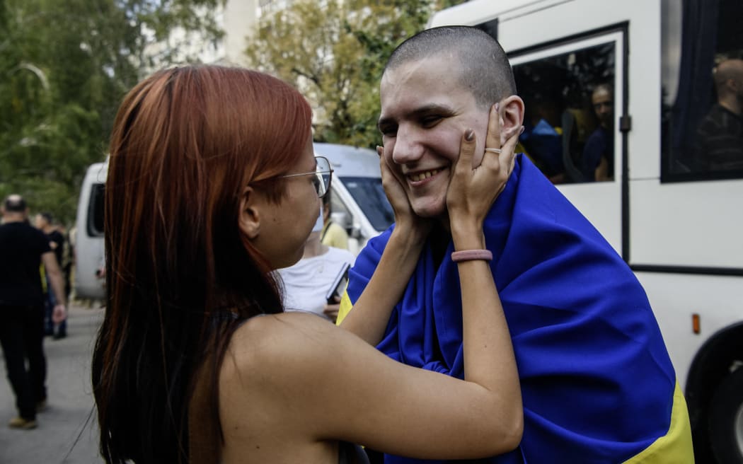 A relative hugs a Ukrainian prisoner of war (POW) who returns from captivity as forty-nine civilian and military Ukrainians return to Ukraine after a swap with Russia in Chernihiv Region, Ukraine, on September 13, 2024. (Photo by Maxym Marusenko/NurPhoto) (Photo by Maxym Marusenko / NurPhoto / NurPhoto via AFP)