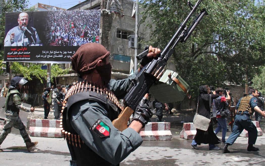 Afghan police clash with protesters during a protest
