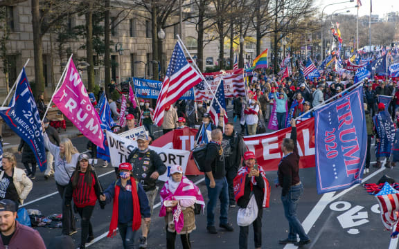 Supporters of US President Donald Trump march on Pennsylvania Avenue to protest the outcome of the 2020 presidential election on December 12, 2020 in Washington, DC. (Photo by Jose Luis Magana / AFP)