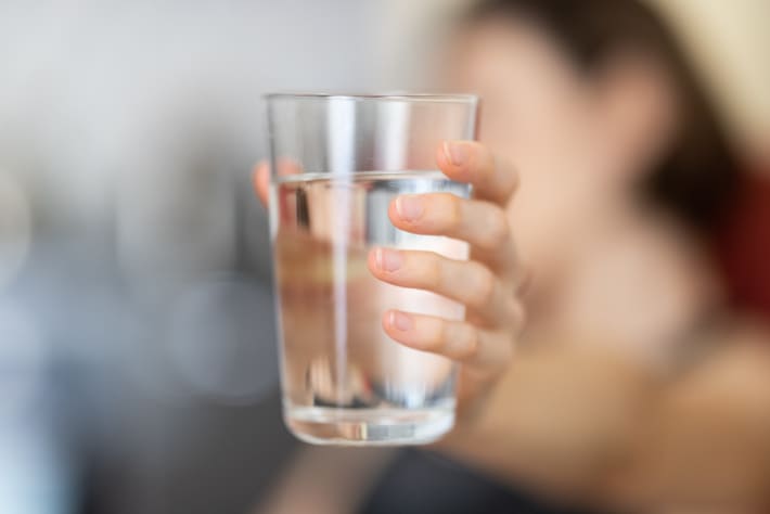 hand holding a glass of water