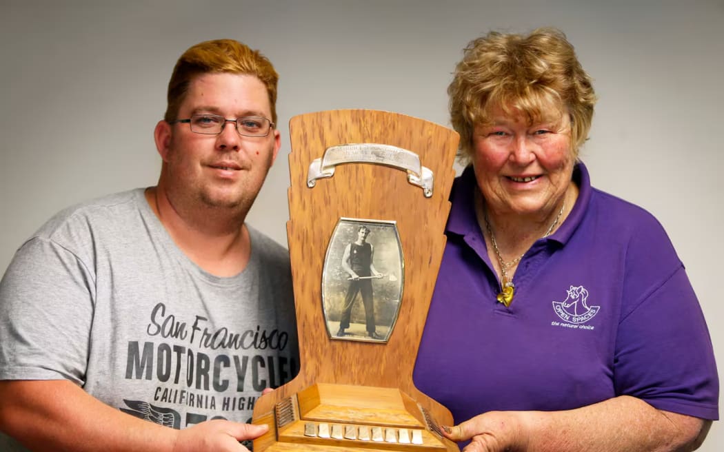 Thomas and Cherry Daly with the historic Mick Griffin Memorial chopping trophy. Photo / NZME